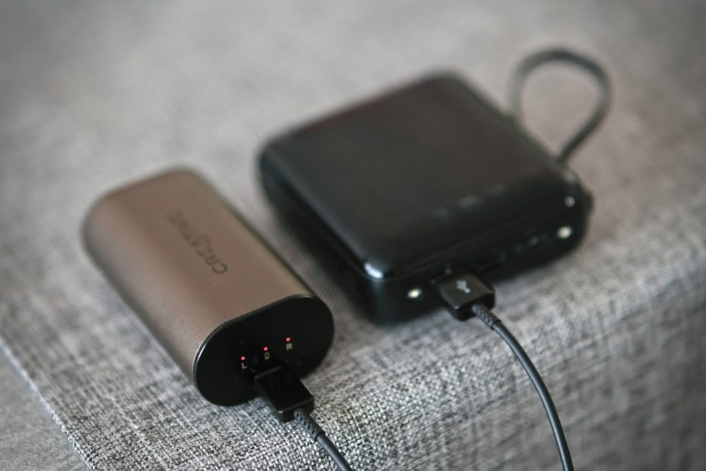 A couple of electronic devices sitting on top of a bed